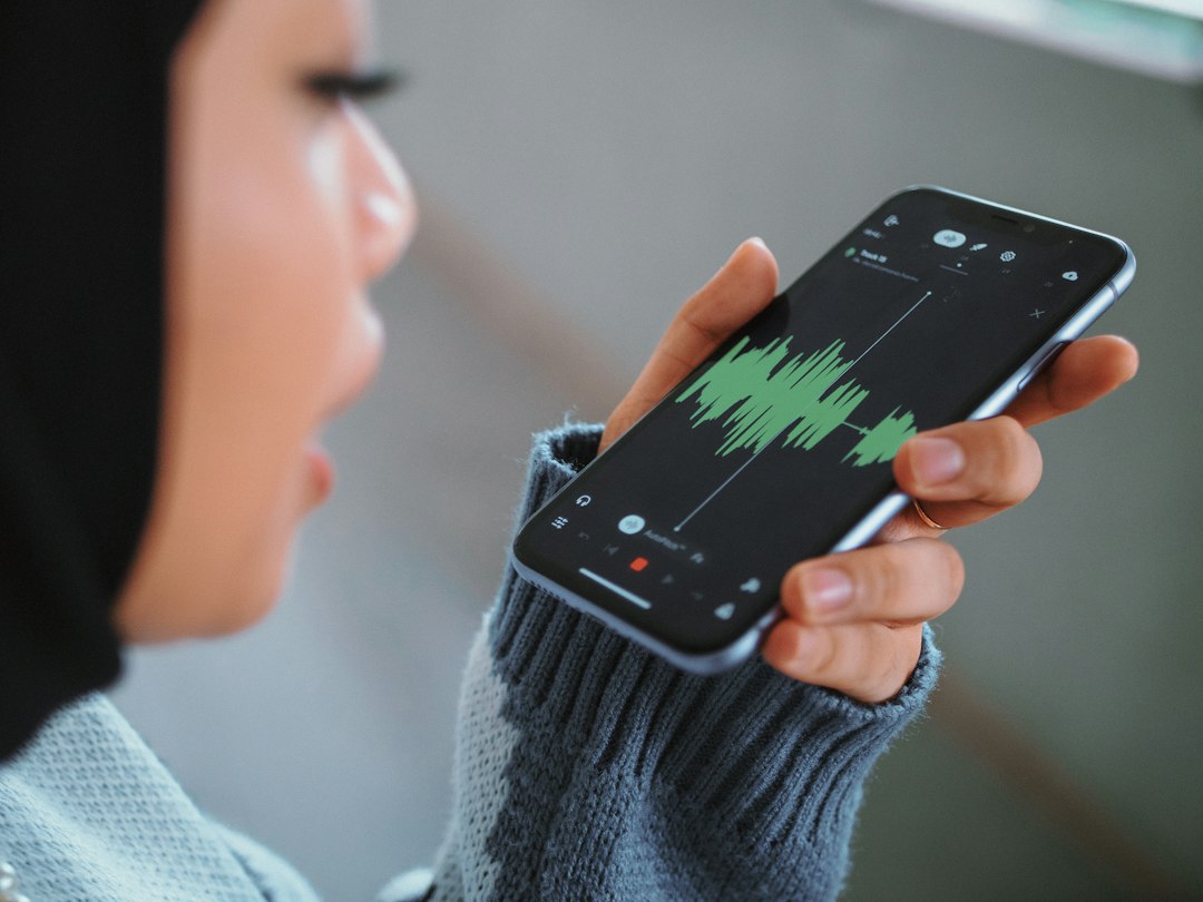 Person using a smartphone representing AI voice assistant applications