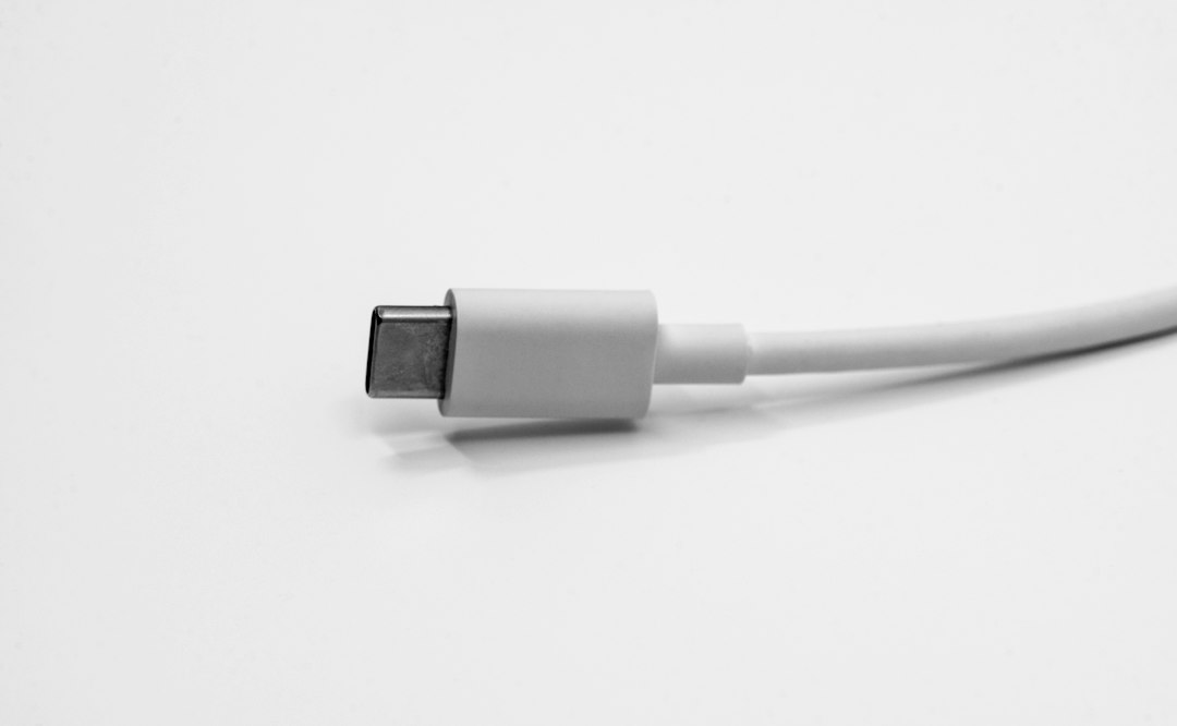 Close-up of a charging cable connector on a light surface