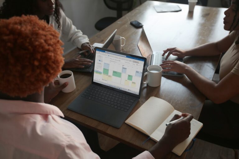 Microsoft laptop in a business meeting illustrating the retirement of the Excel COPILOT function