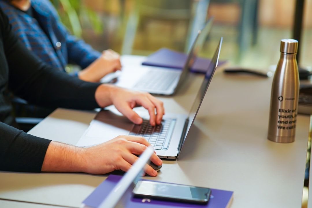 Professional using a laptop in a meeting room representing GPT-6 Astra research, analysis and knowledge work