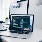 Developer workspace with laptop displaying code