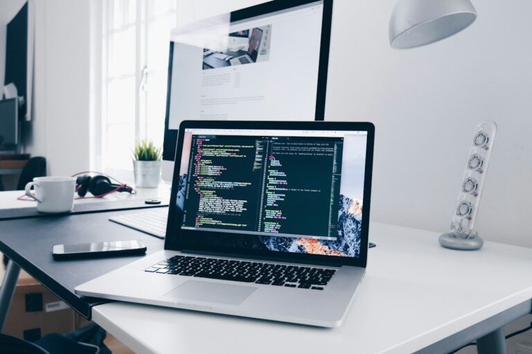 Developer workspace with laptop displaying code