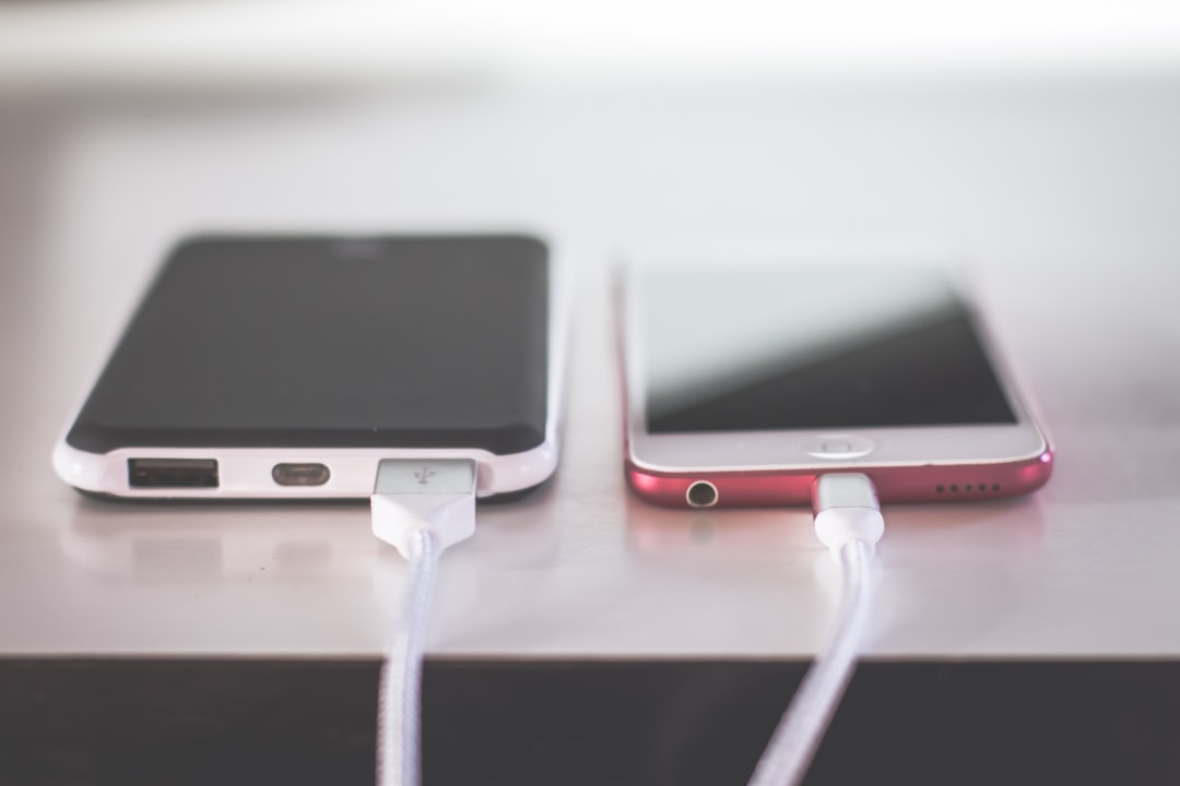 Two smartphones resting on a white table