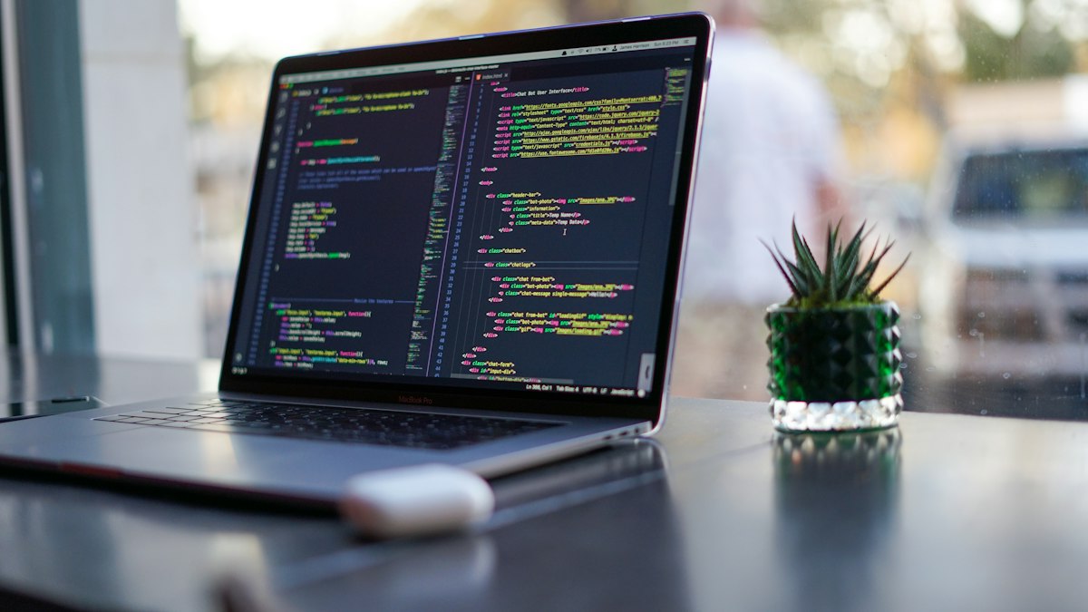Developer laptop with code representing TauGrid CLI workflows for Kubernetes AI jobs