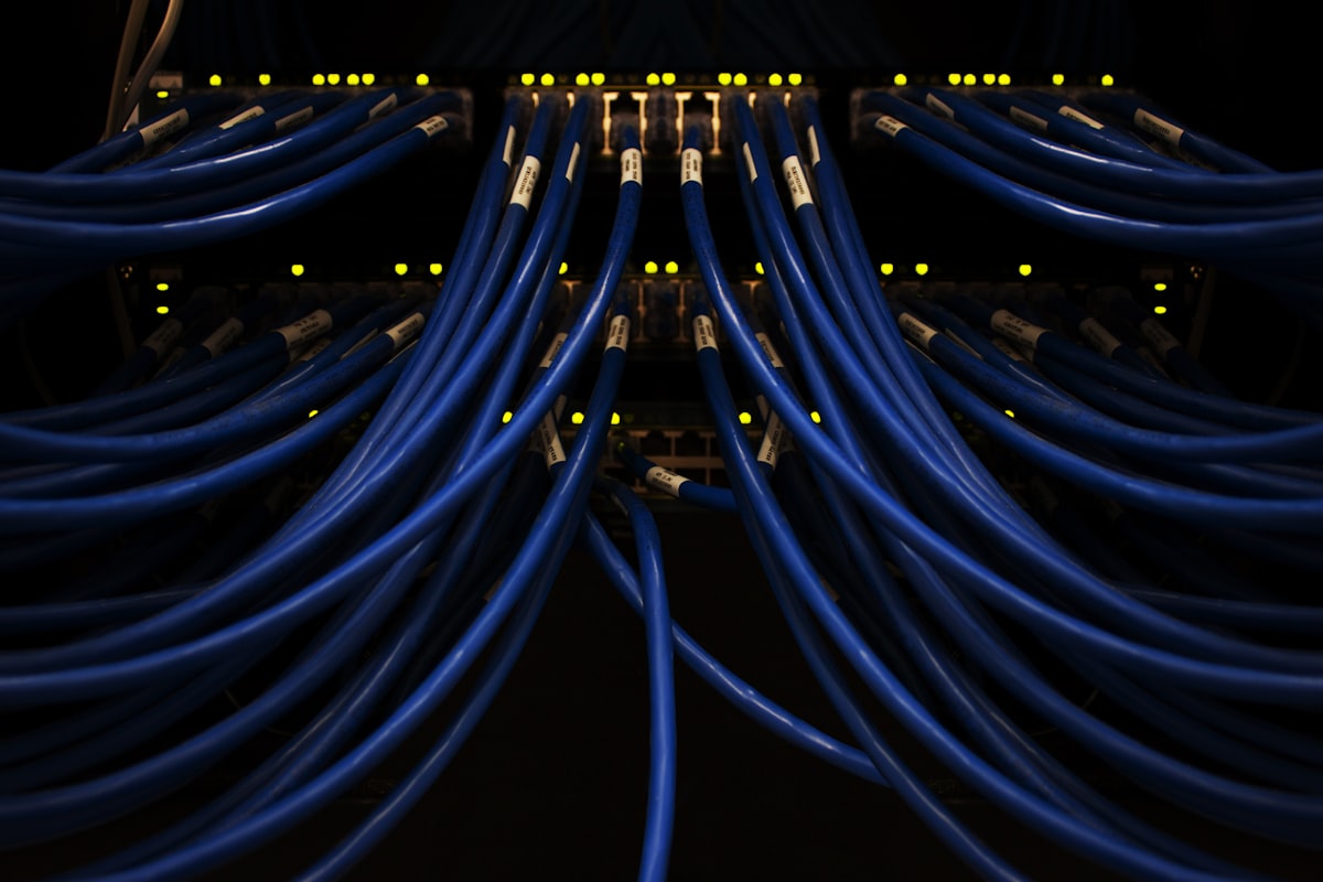 Blue network cables in a data center illustrating connectivity for Kubernetes AI infrastructure