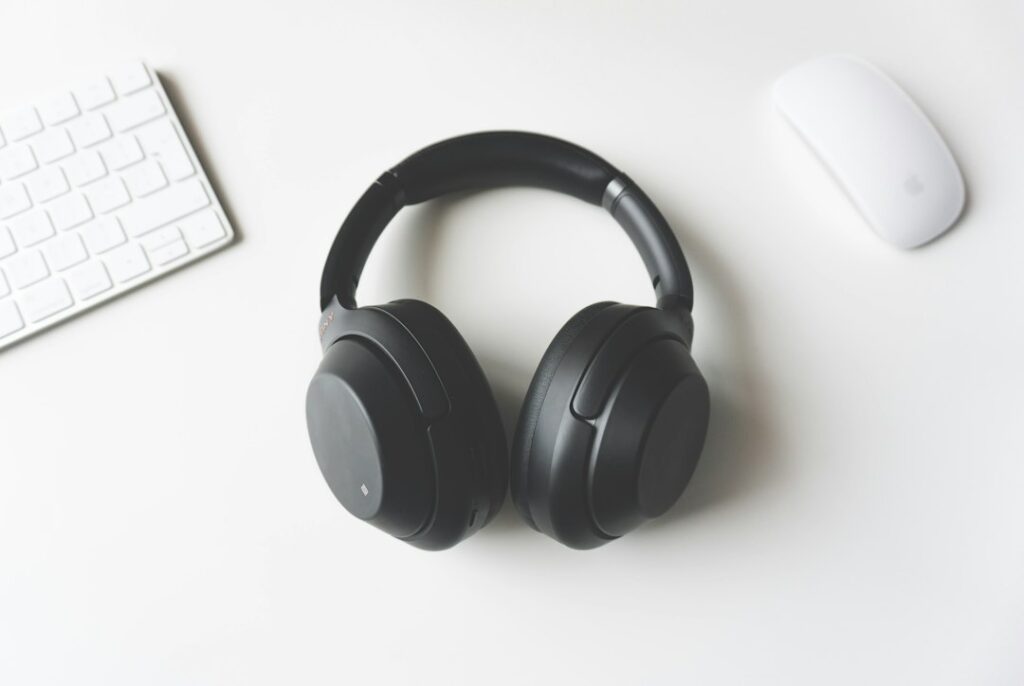 Headphones beside a computer representing the unresolved USB Audio Class 1.0 Code 10 and no-sound issue in Windows 11
