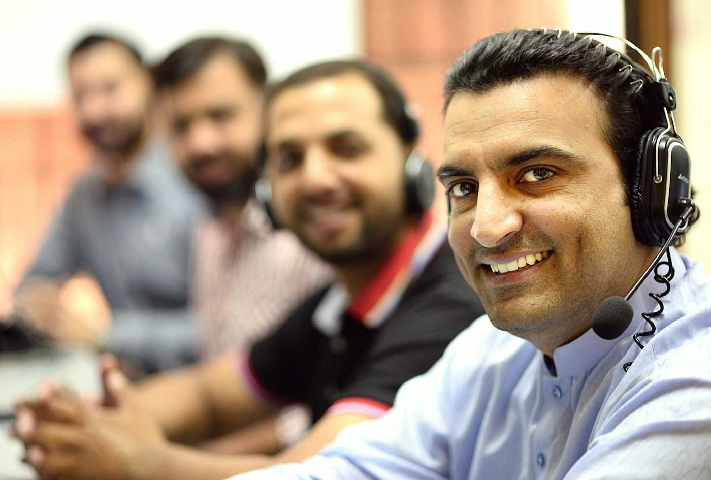 Call center team working at computers, illustrating voice AI customer support workflows