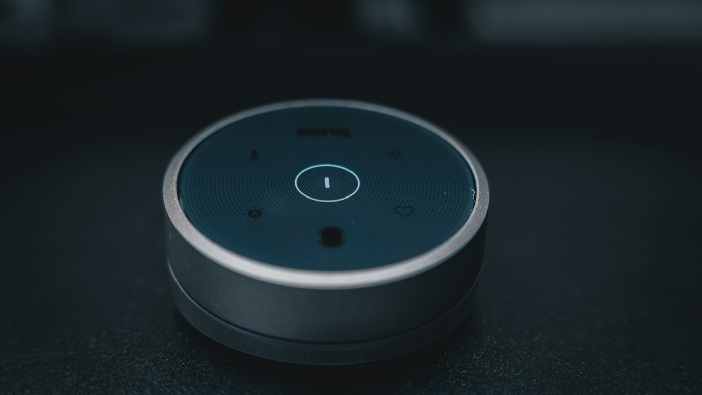 Close-up of a smart voice device on a table illustrating live AI assistant use