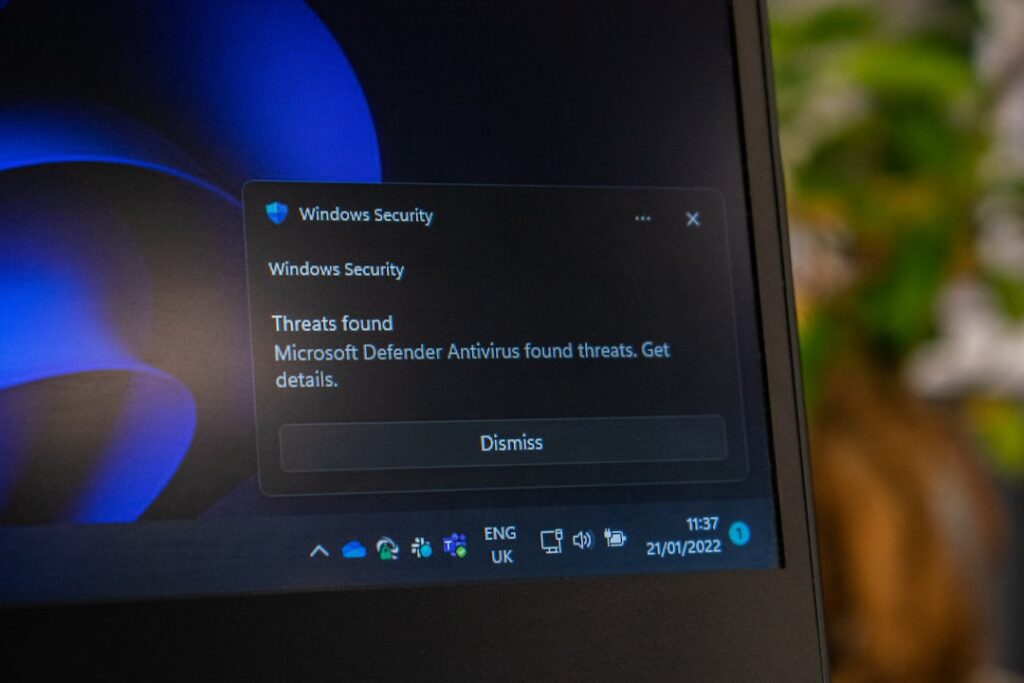 Windows Security screen on a laptop representing security protections included in KB5129195