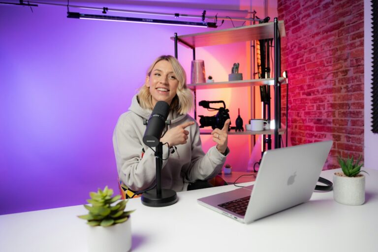 Video creator recording in a studio with microphone and laptop