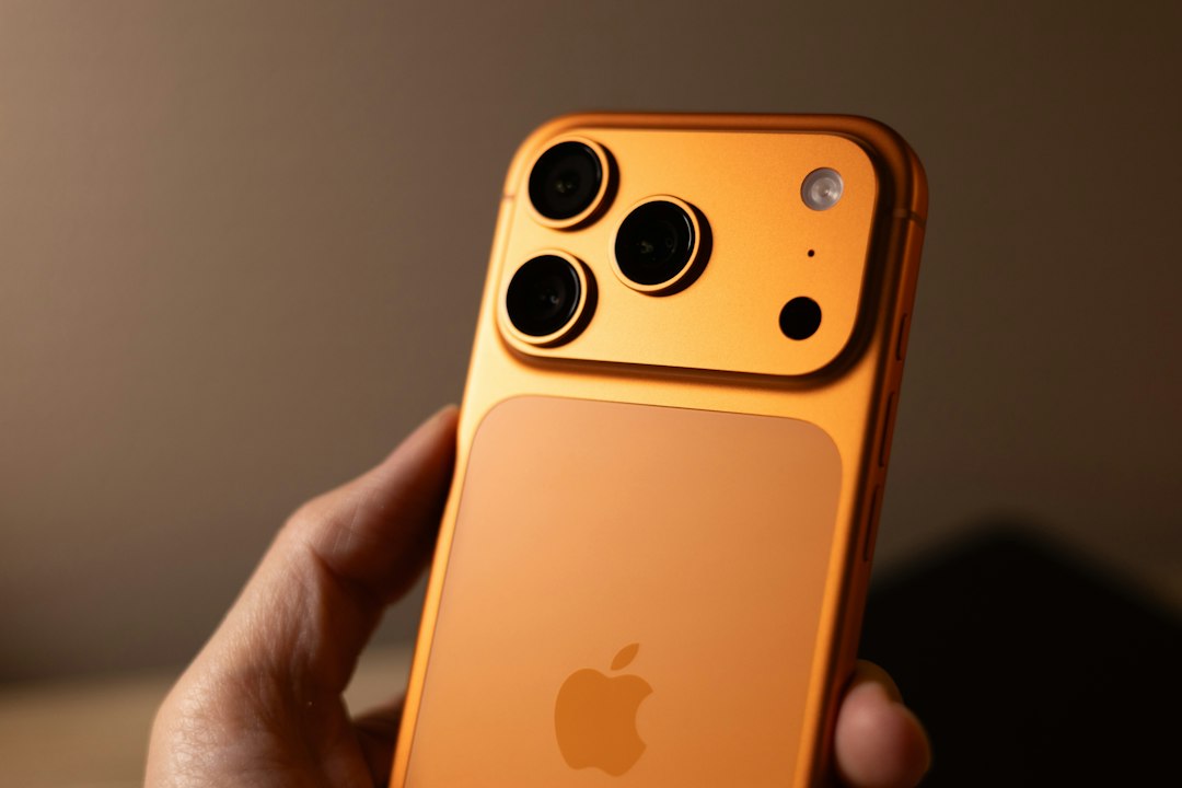 Person holding an iPhone 17 Pro, one of the devices that supports advanced Siri AI features in iOS 27