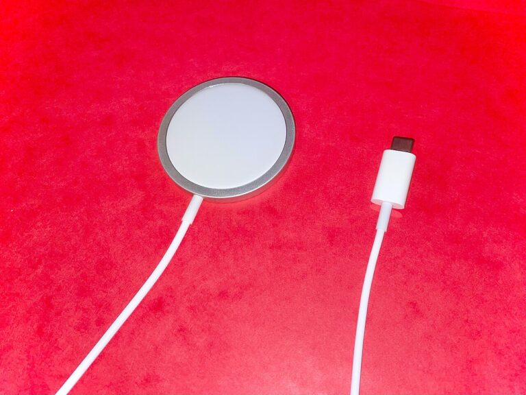 Original photograph showing a MagSafe wireless charging puck and USB-C cable for iPhone, not a charging repair test